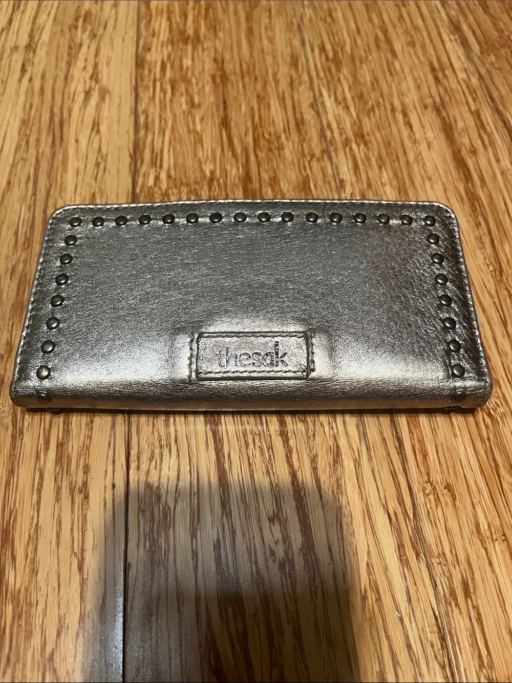 The Sak Metallic Gold wallet with  Stud Trim